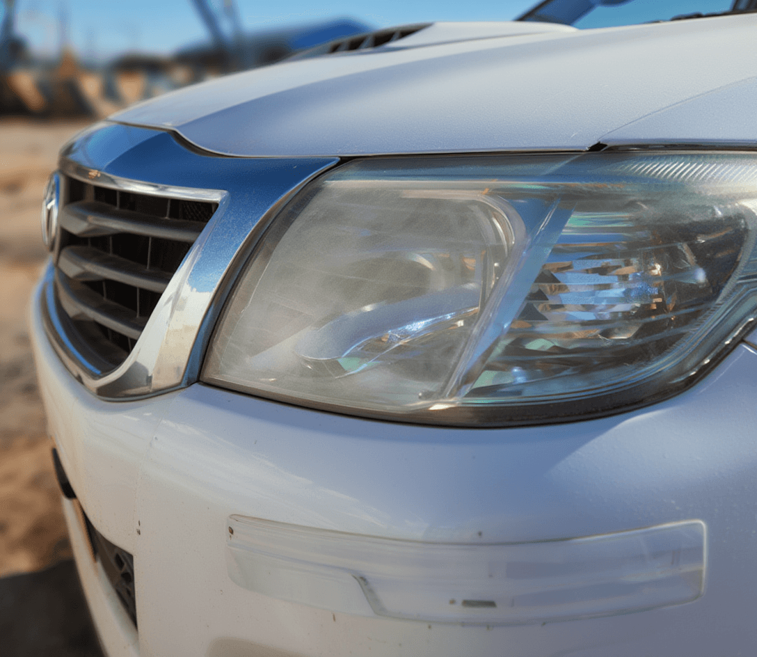 Óptica delantera de Toyota Hilux 2014 opaca y amarillenta antes del pulido de ópticas en Lusttro Córdoba